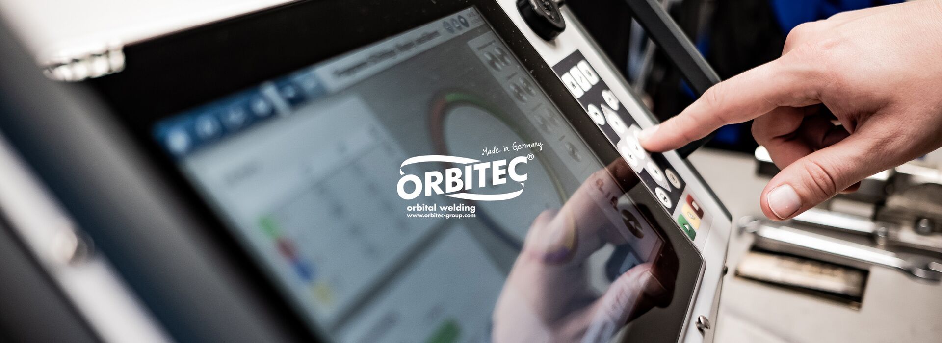 Employee operates the new user interface of a orbital welding device.
